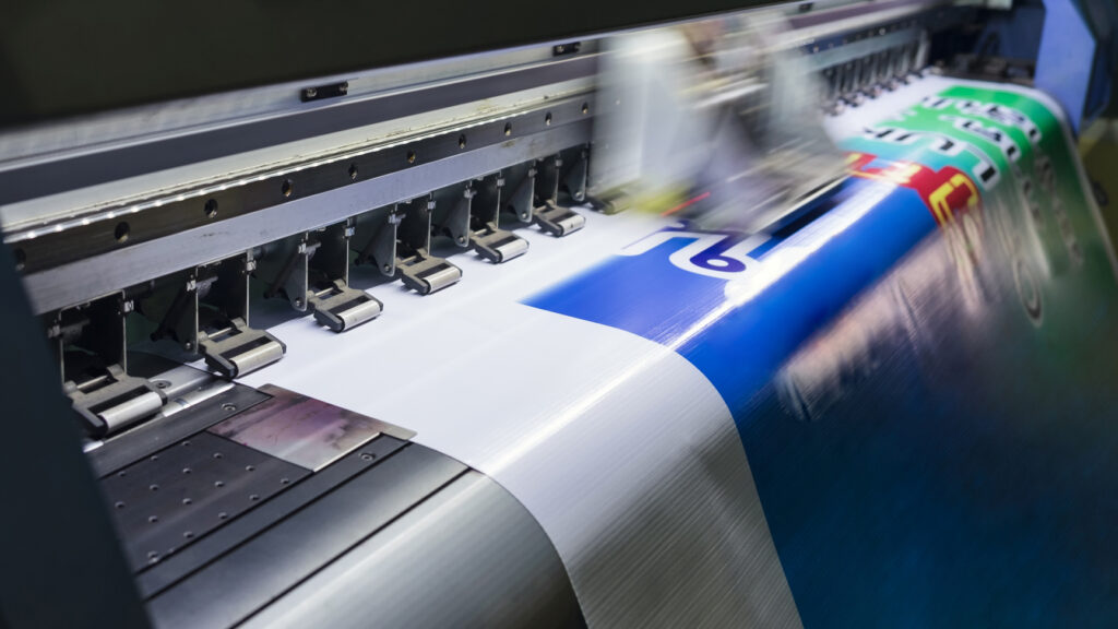 Large format printing machine in operation producing high-quality graphics, commerical print production London