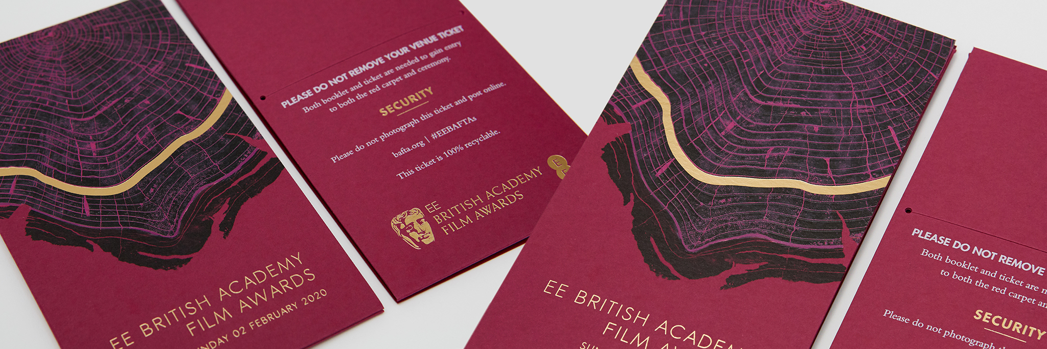 Luxury award tickets featuring gold foil detailing and textured red finish, premium event print