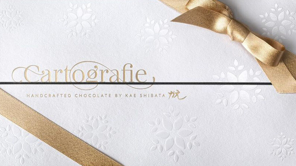 Luxury chocolate packaging with gold foil lettering and embossed pattern, premium packaging print
