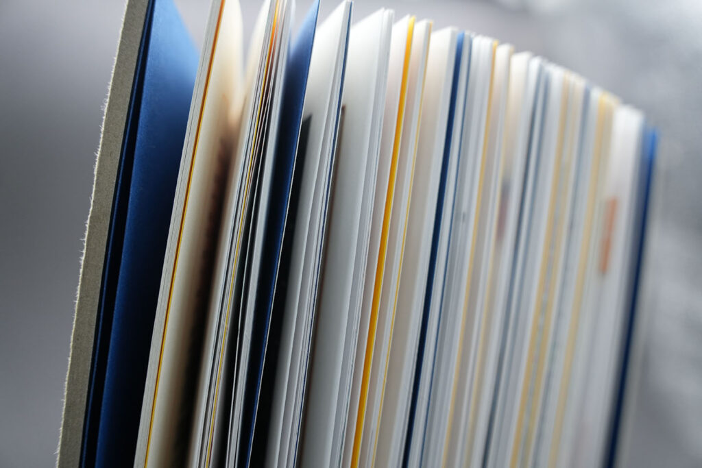 Close-up of a bespoke printed book showcasing premium binding, high-quality paper stocks and luxury book production craftsmanship