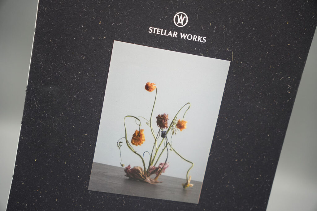 Custom book design featuring a premium cover printed on textured recycled paper with mounted photographic artwork, showcasing luxury publication printing and book production