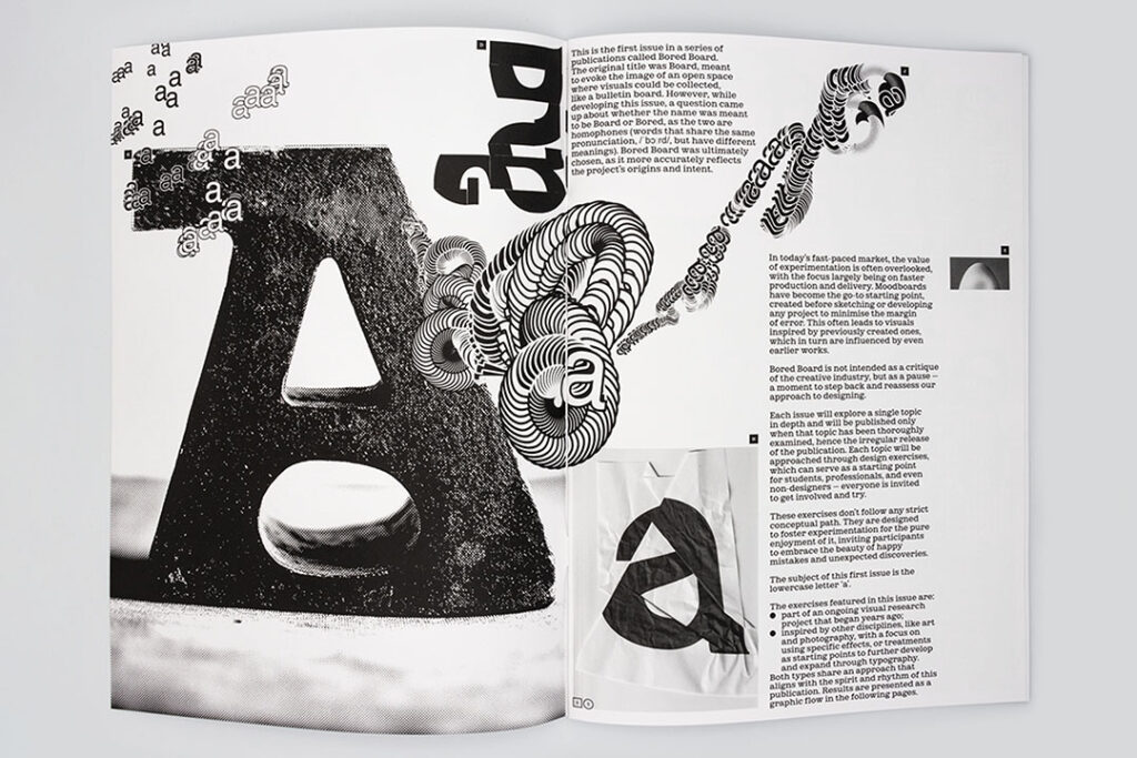 Open printed publication displaying bold typographic design and premium editorial printing