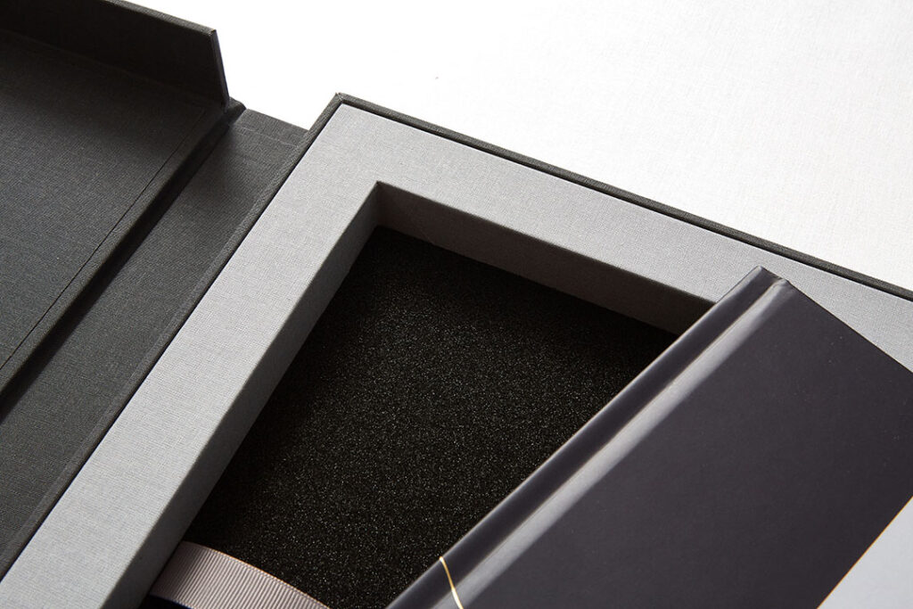Open luxury rigid presentation box with custom foam insert and premium lined interior for product protection